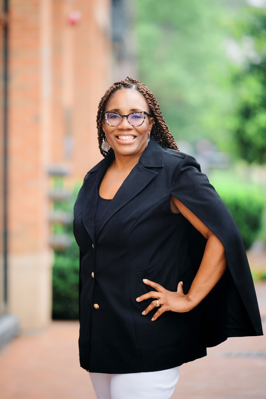 Dr. Linda McGhee, a black woman, is smiling while wearing glasses and a black blazer
